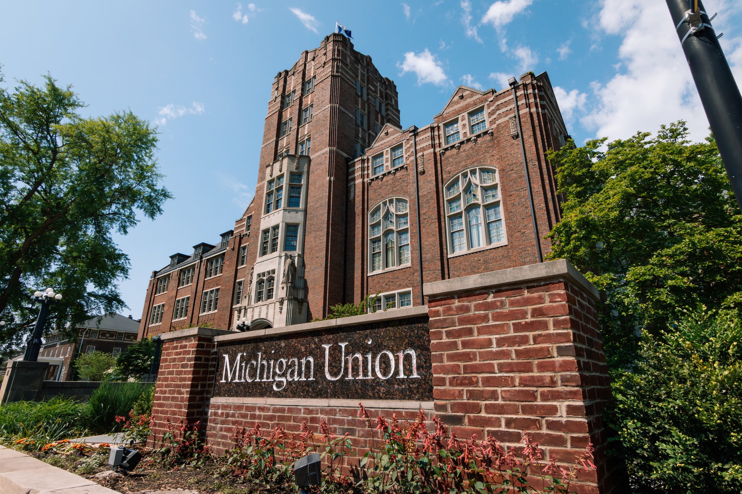 The Michigan Union building's exterior view with its brick facade and blue sky.