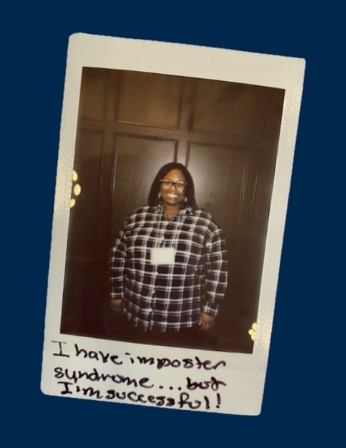 smiling black woman with glasses and plaid shirt