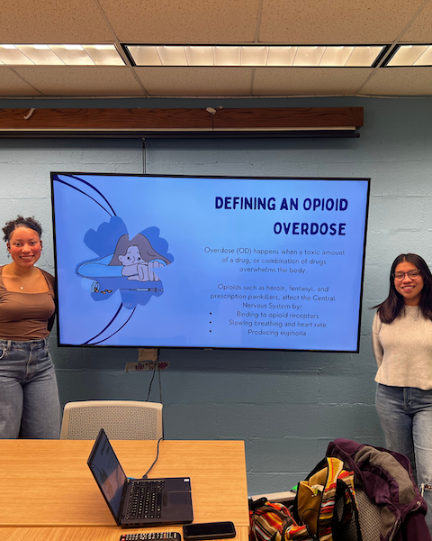 Students give a presentation regarding opioid overdose.